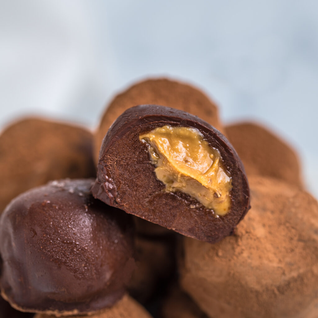 vegan protein chocolate filled with peanut butter showing the half section of the chocolate