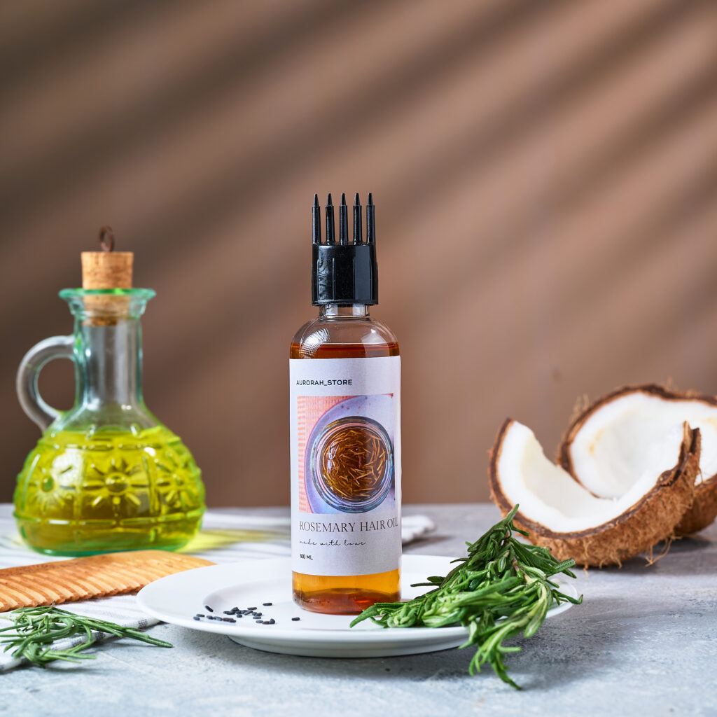 hair oil product photography in a bright setup with the ingredients around